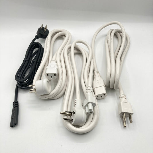 Close view of a white power cord with an angled three-prong grounded plug beside a C13 connector.