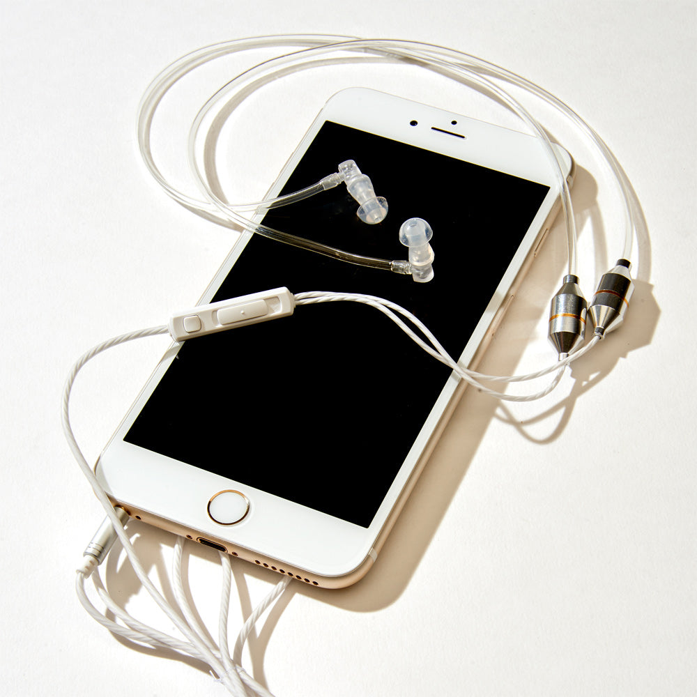 White iPhone with SYB Wrap-Around Air Tube Headphone Headset connected, earbuds displayed on screen, overhead flat lay view.