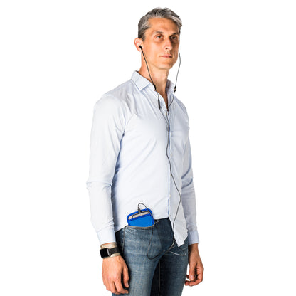 Man wearing light blue shirt with SYB Pouch in blue attached to jeans waistband and earbuds around neck, front view.