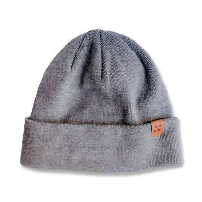 Gray ribbed SafeSleeve Beanie with folded cuff and small orange leather patch detail on white background.