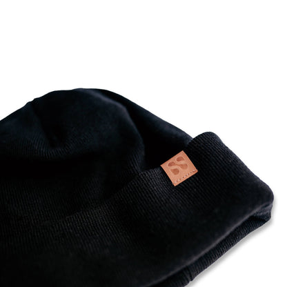 Black SafeSleeve Beanie with tan leather logo patch, displayed on white background.