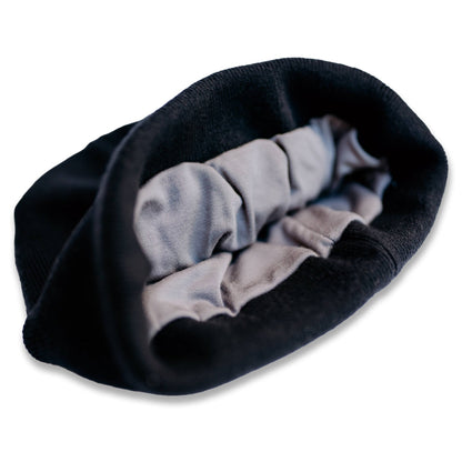 SafeSleeve Beanie with gray and black fabric layers bunched together, showing interior lining detail and texture.