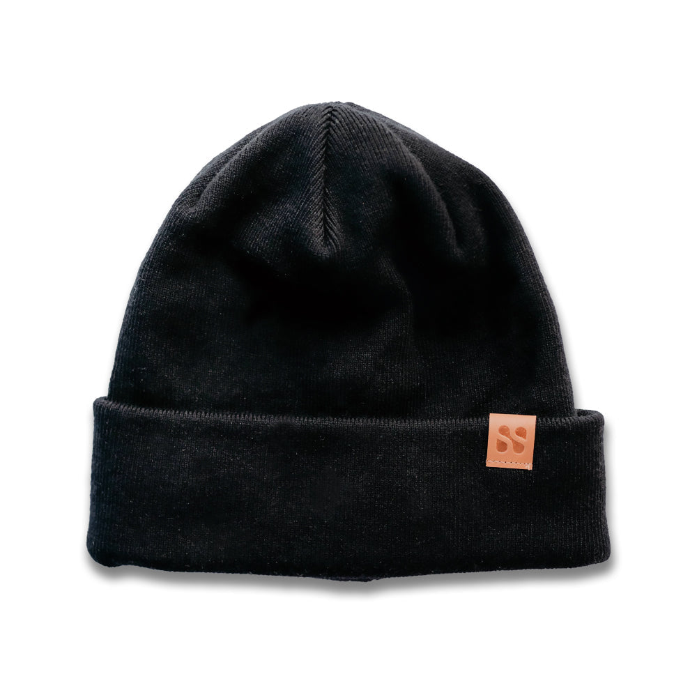 Black SafeSleeve Beanie with rolled cuff and copper brand label patch, front view against white background.