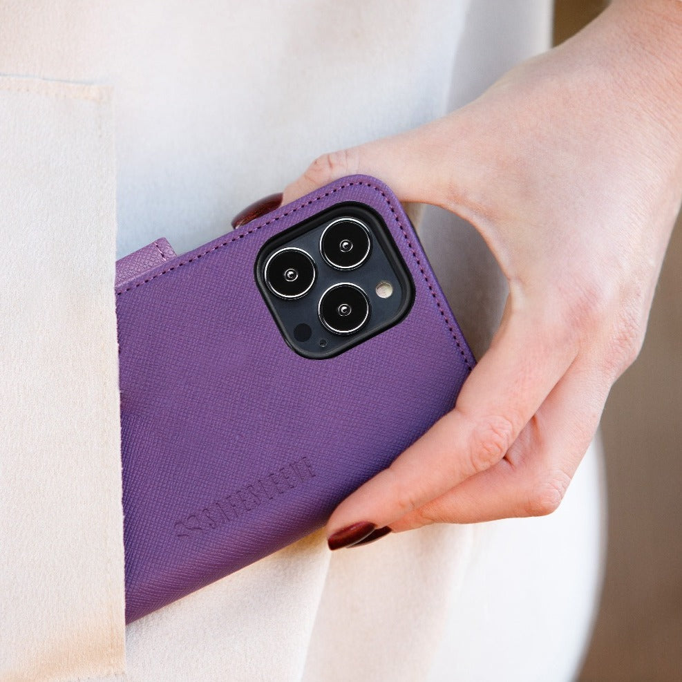 Purple SafeSleeve Case for iPhone held in hand, showing triple camera cutout and textured fabric exterior.