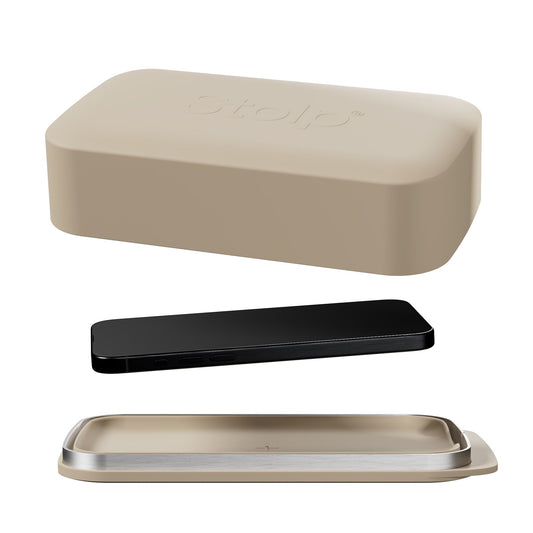 Sand-colored Bagby Stolp Faraday phone box shown open with its lid, metal-rimmed tray and a black phone laid between them on white.