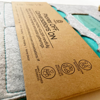 Bagby 4 Pocket Phone Holder packaging detail showing care instructions and recycling symbols on kraft cardboard box.
