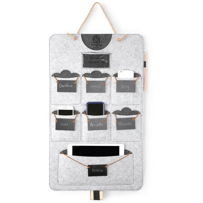 Gray felt Bagby FAMILY organizer with six phone pockets on chalkboard name tags and a lower tablet pocket, with a chalk pencil.