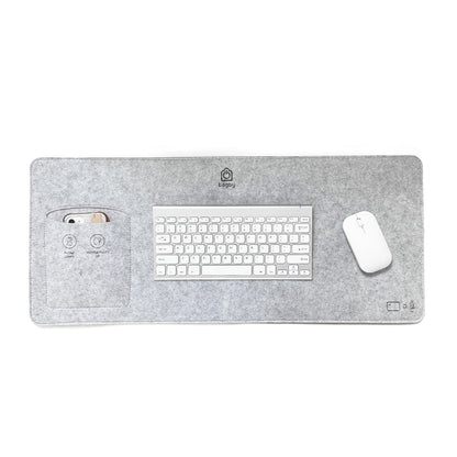 Bagby MAT desk pad in gray felt laid flat with a white wireless keyboard and mouse, and a phone tucked in the side pocket.