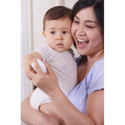 Mother holding smiling baby while using Bebcare Low-EMF IQ WiFi HD Baby Monitor on mobile device.