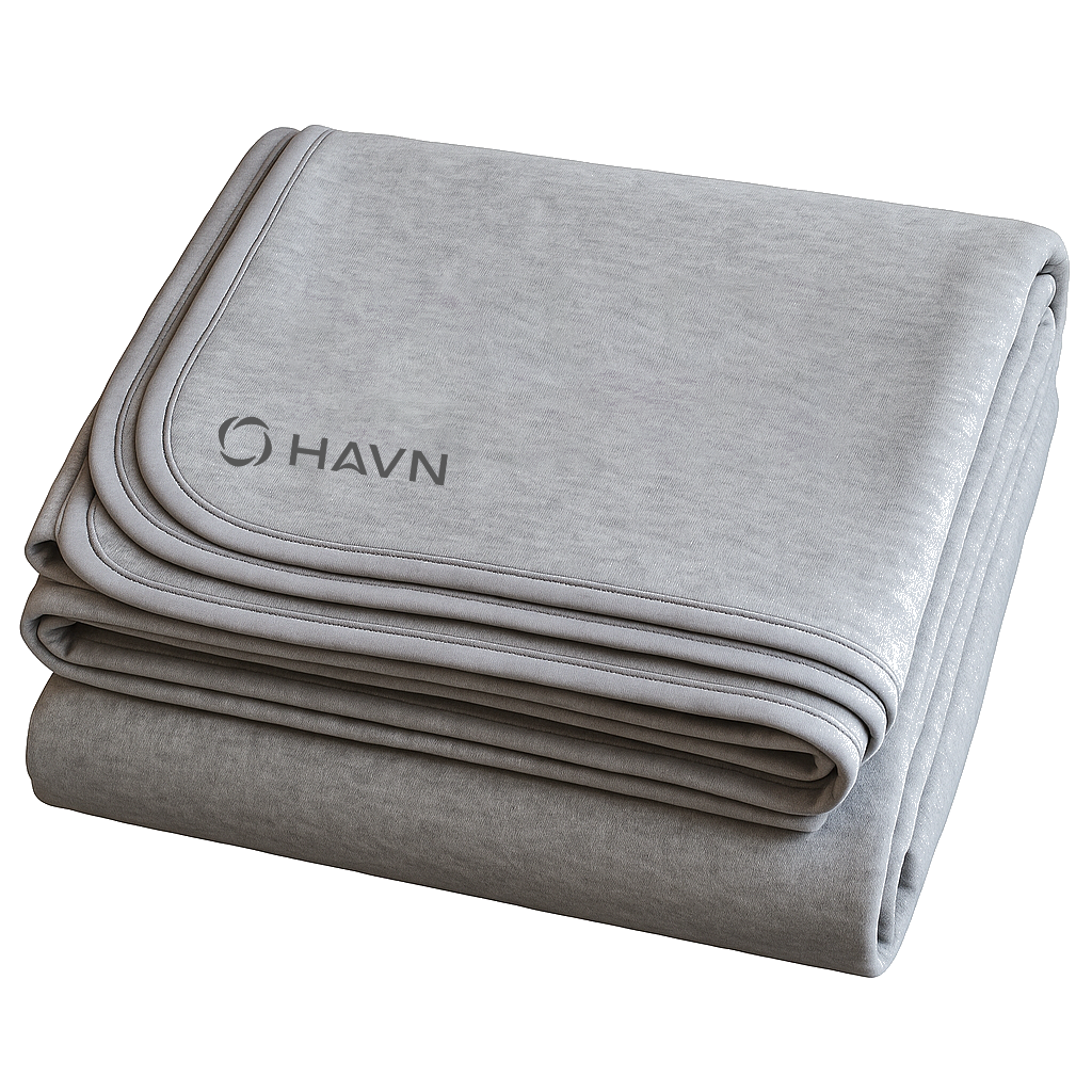 HAVN WaveStopper™ Blanket folded in layers showing light and dark gray fabric with piping detail and logo.