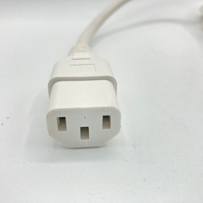 Close view of a white C13 appliance connector at the end of a power cord.