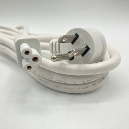 Close view of a white angled grounded plug and the three-hole C5 clover-leaf connector at the other end of the cord, with the cord jacket printing visible.