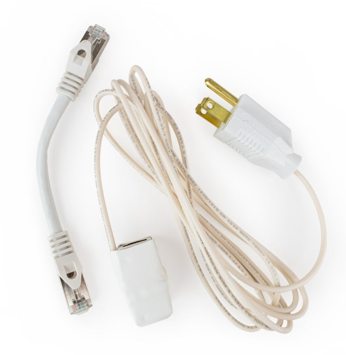 White Ethernet grounding adapter kit laid out with a short shielded patch cable, the grounding adapter and a coiled grounding cord with a three-prong plug.