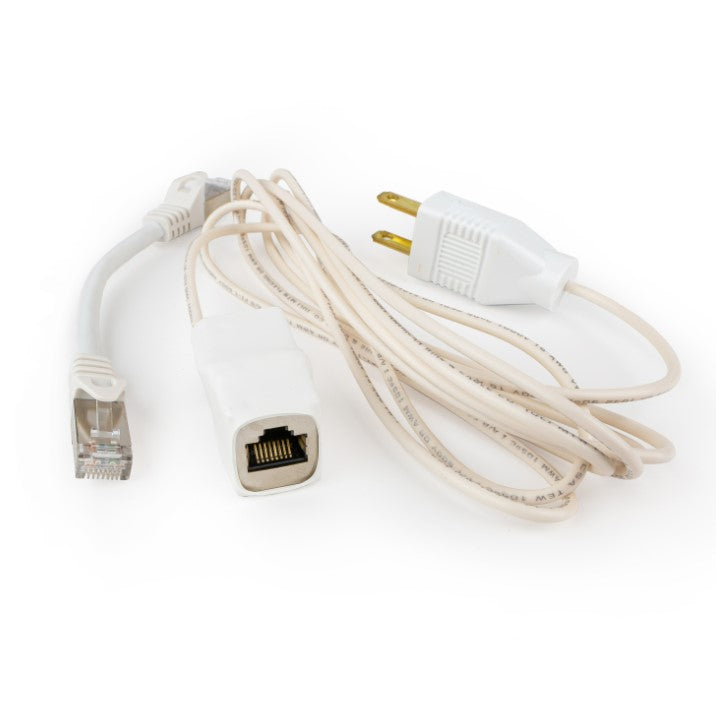White grounding adapter with its Ethernet port facing forward, beside the short patch cable and the coiled grounding cord.