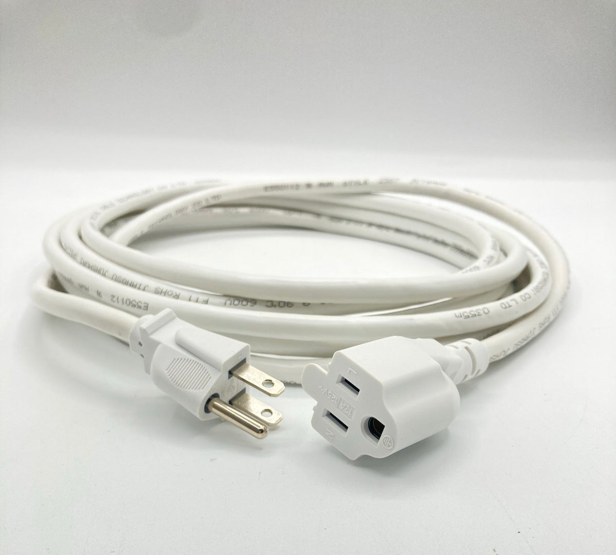 Coiled white extension cord with a three-prong grounded plug and an angled outlet end, photographed on a white surface.