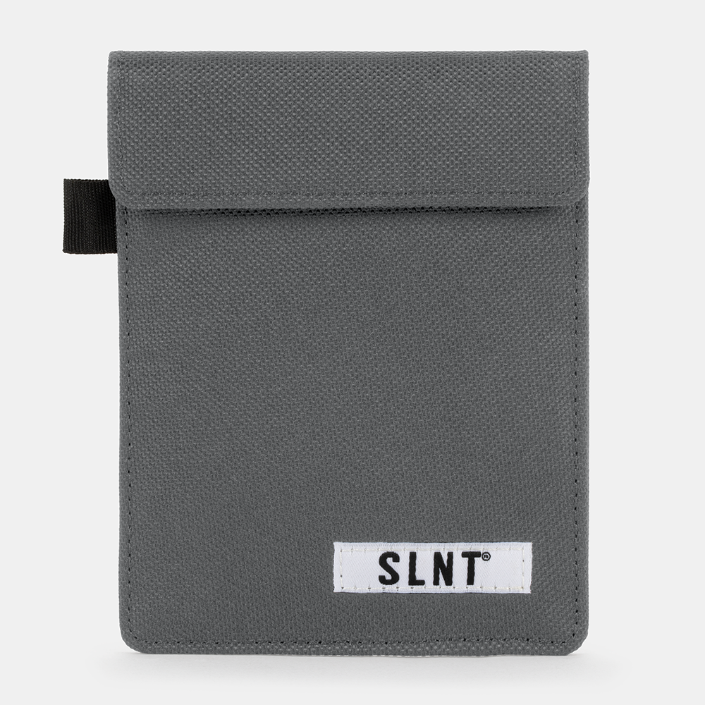 Gray canvas Faraday Key Fob Bag with SLNT brand label and black carrying loop, front view.