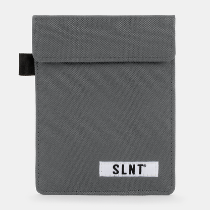 Gray canvas Faraday Key Fob Bag with SLNT brand label and black carrying loop, front view.