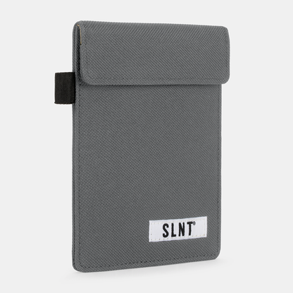 Gray Faraday Key Fob Bag with black webbing strap and SLNT branding label, front view angled perspective.