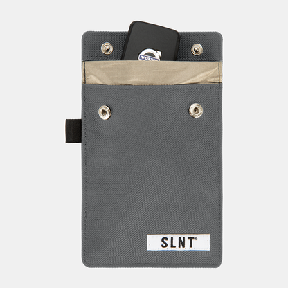 Gray Faraday Key Fob Bag with tan interior pocket, metal grommets, black strap, and SLNT brand label, containing a black key fob.