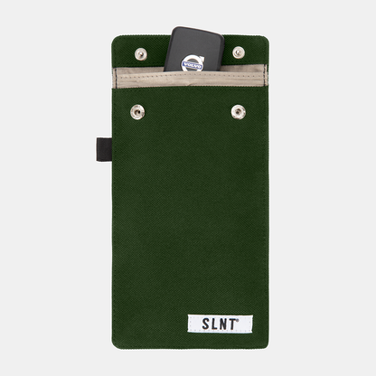 Green Faraday Key Fob Bag with Volvo key fob inside top pocket, showing front view with snap closures and SLNT branding label.