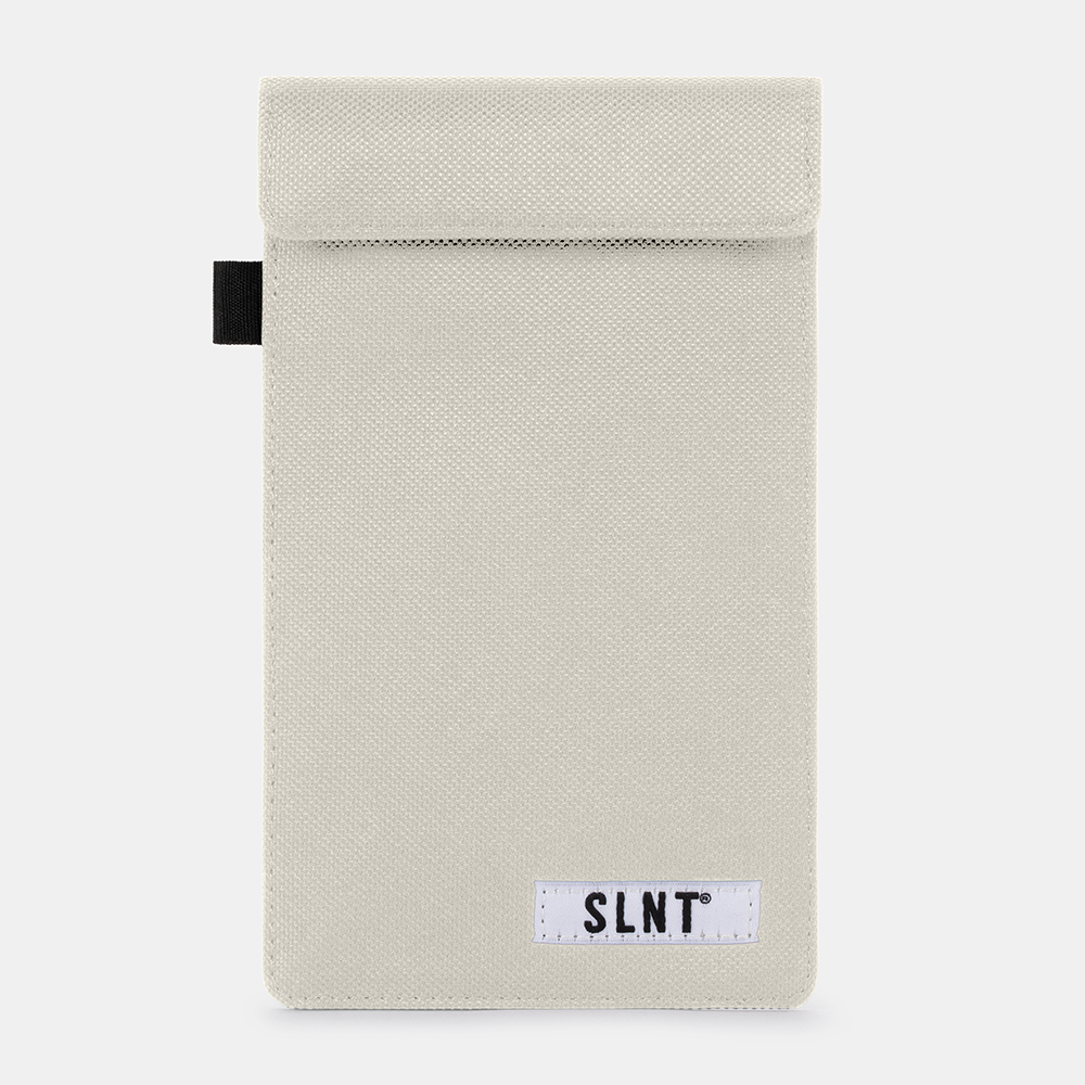 Beige canvas Faraday Key Fob Bag with black handle tab and SLNT brand label, front view against white background.