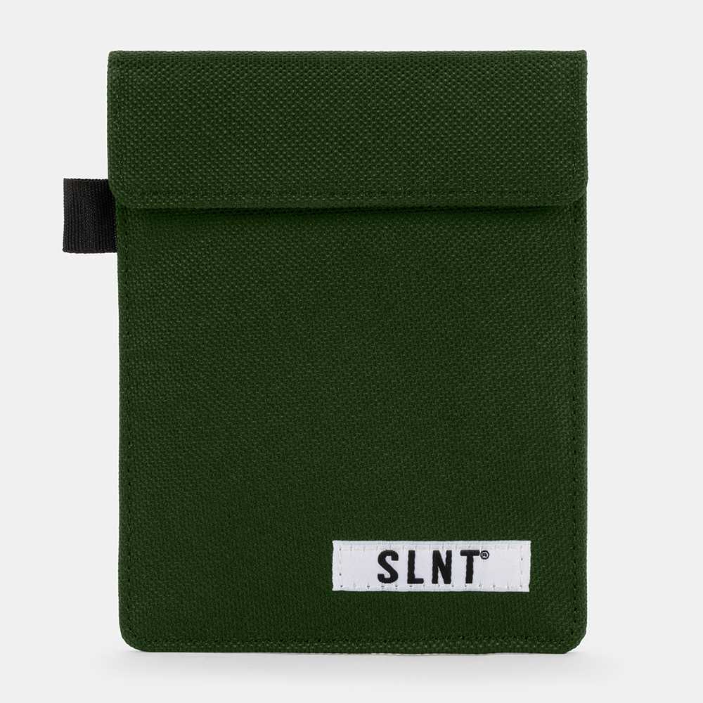 Green canvas Faraday Key Fob Bag with black pull tab and white SLNT brand label on front.