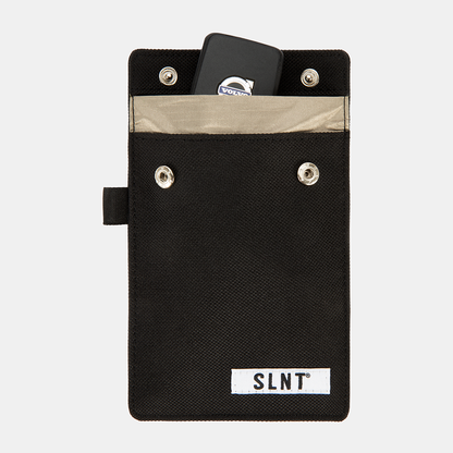 Black Faraday Key Fob Bag with tan interior pocket, metal snap buttons, and SLNT branding label, shown open with car key inside.
