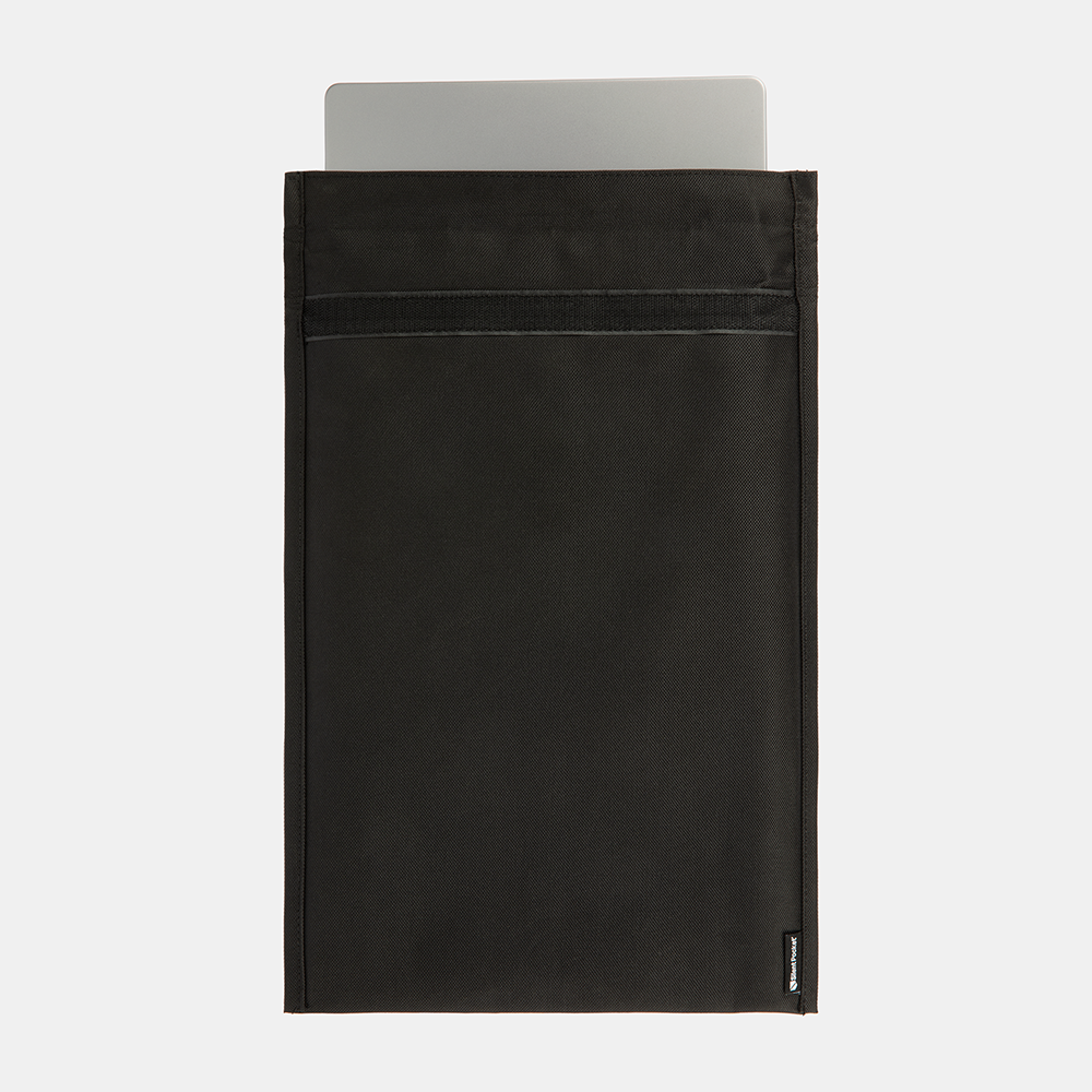 SLNT Faraday Laptop Bag in black with silver laptop partially inserted into the open top compartment.