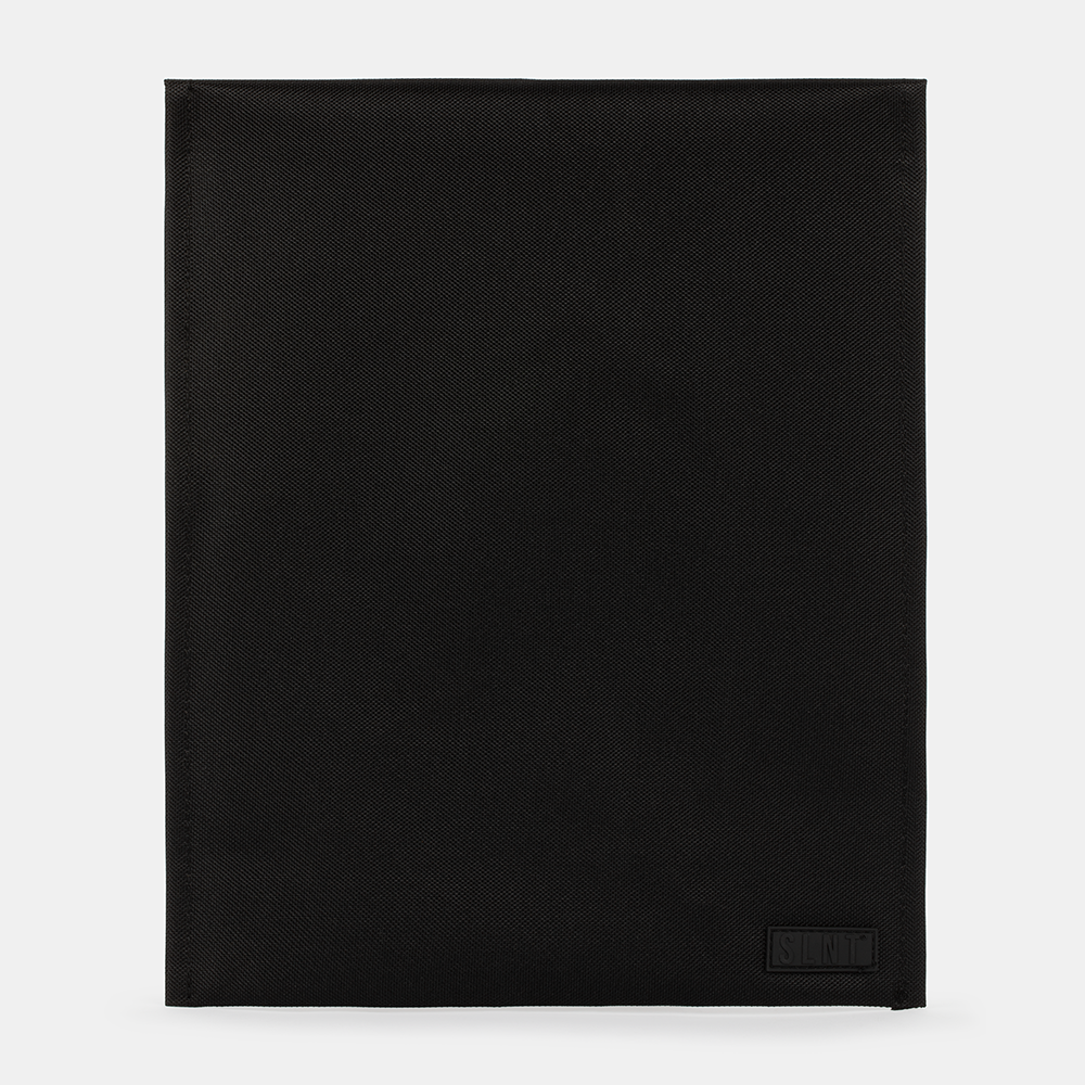 SLNT Faraday Laptop Bag in black with textured fabric, flat lay view showing full front panel and brand label.