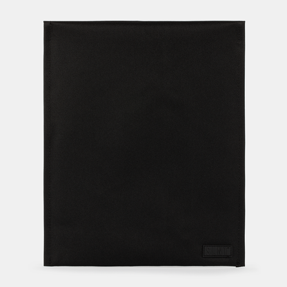 SLNT Faraday Laptop Bag in black with textured fabric, flat lay view showing full front panel and brand label.