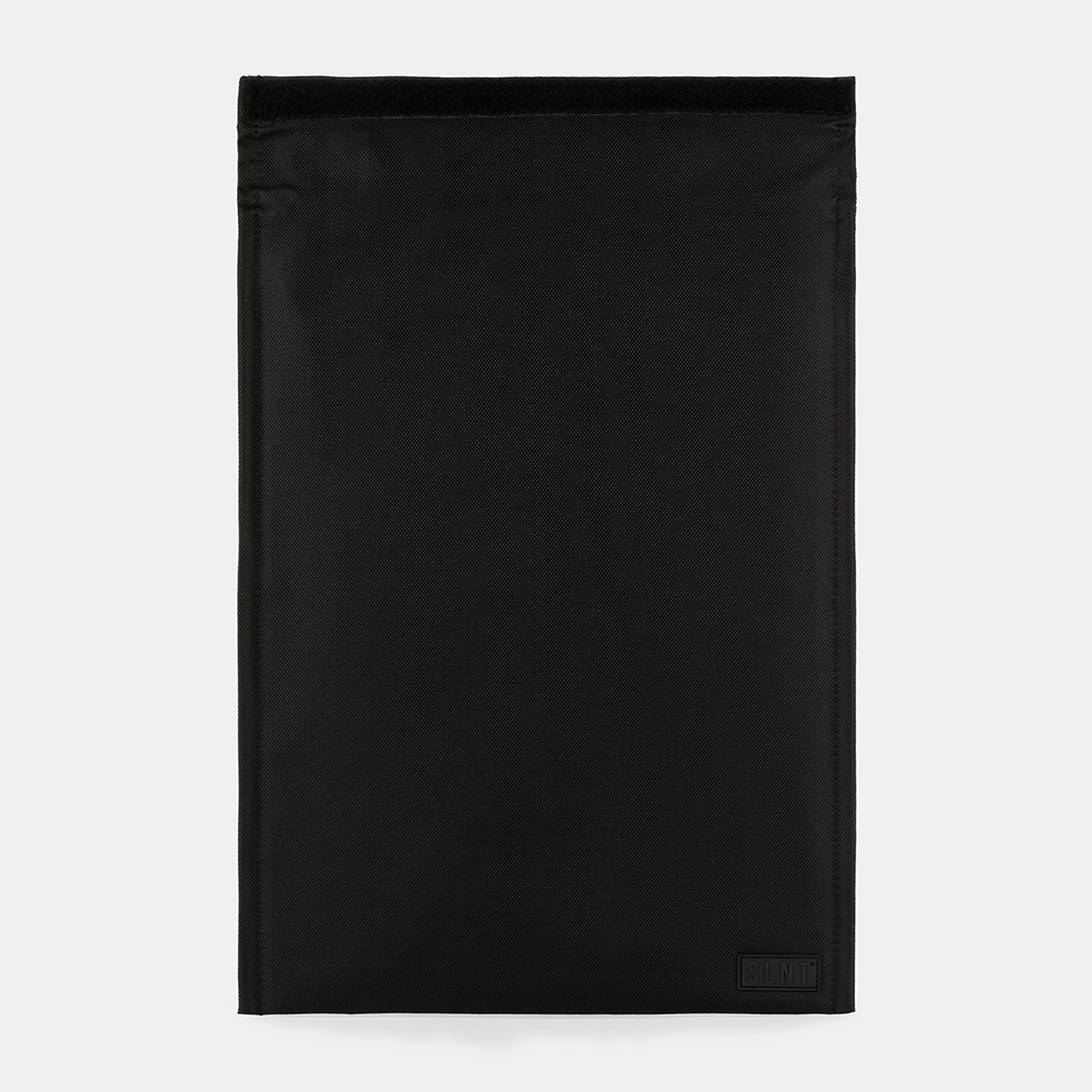 SLNT Faraday Laptop Bag in black, flat lay front view showing minimalist design with small logo patch in lower right corner.