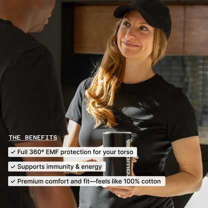 Woman wearing black HAVN WaveStopper T-Shirt 2.0 holding mug, displaying benefits: EMF protection, immunity support, and cotton comfort.