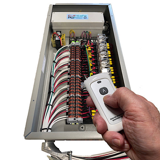 EMFSafe Remote Cut Off Kill Switch control panel opened showing internal wiring and circuitry with wireless remote held in hand.