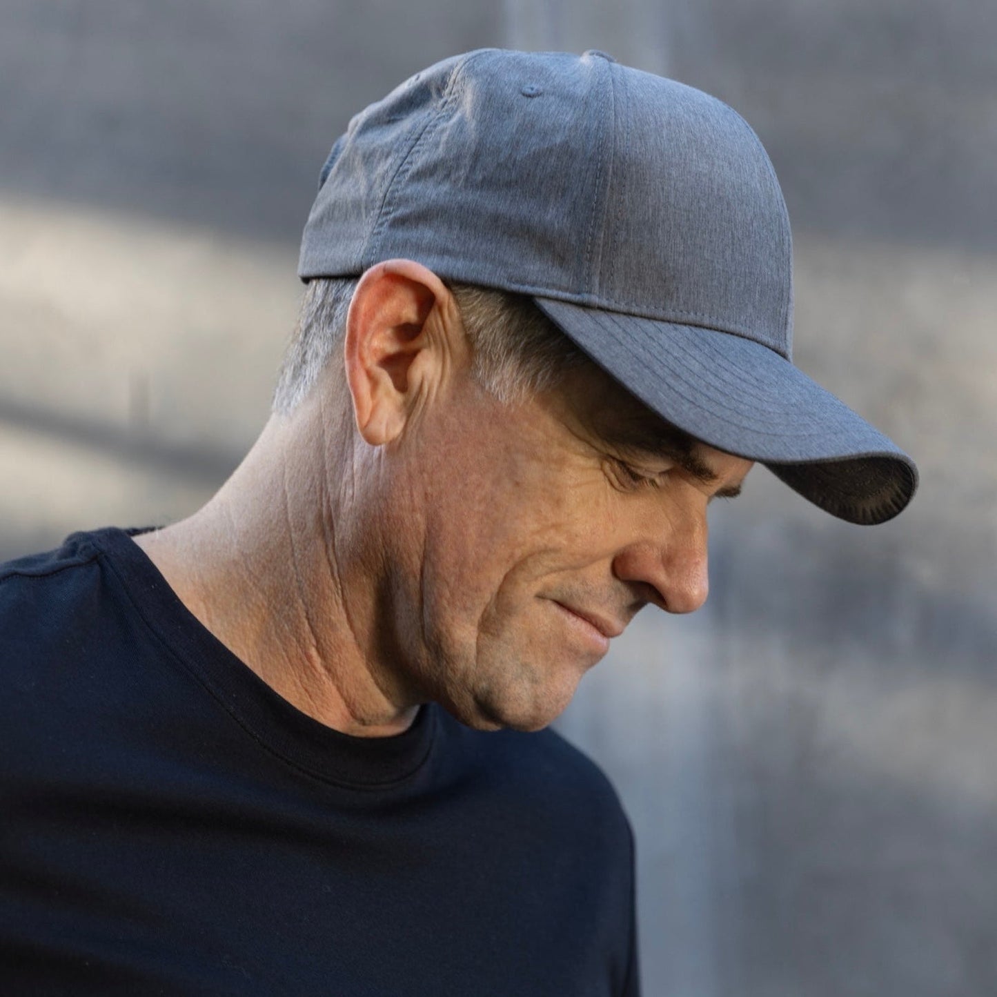 Man wearing light blue HAVN WaveStopper™ Performance Cap in side profile view, showing fit and design details.