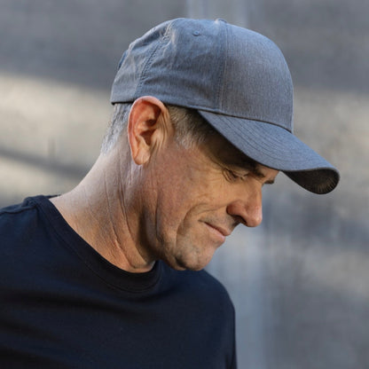 Man wearing light blue HAVN WaveStopper™ Performance Cap in side profile view, showing fit and design details.