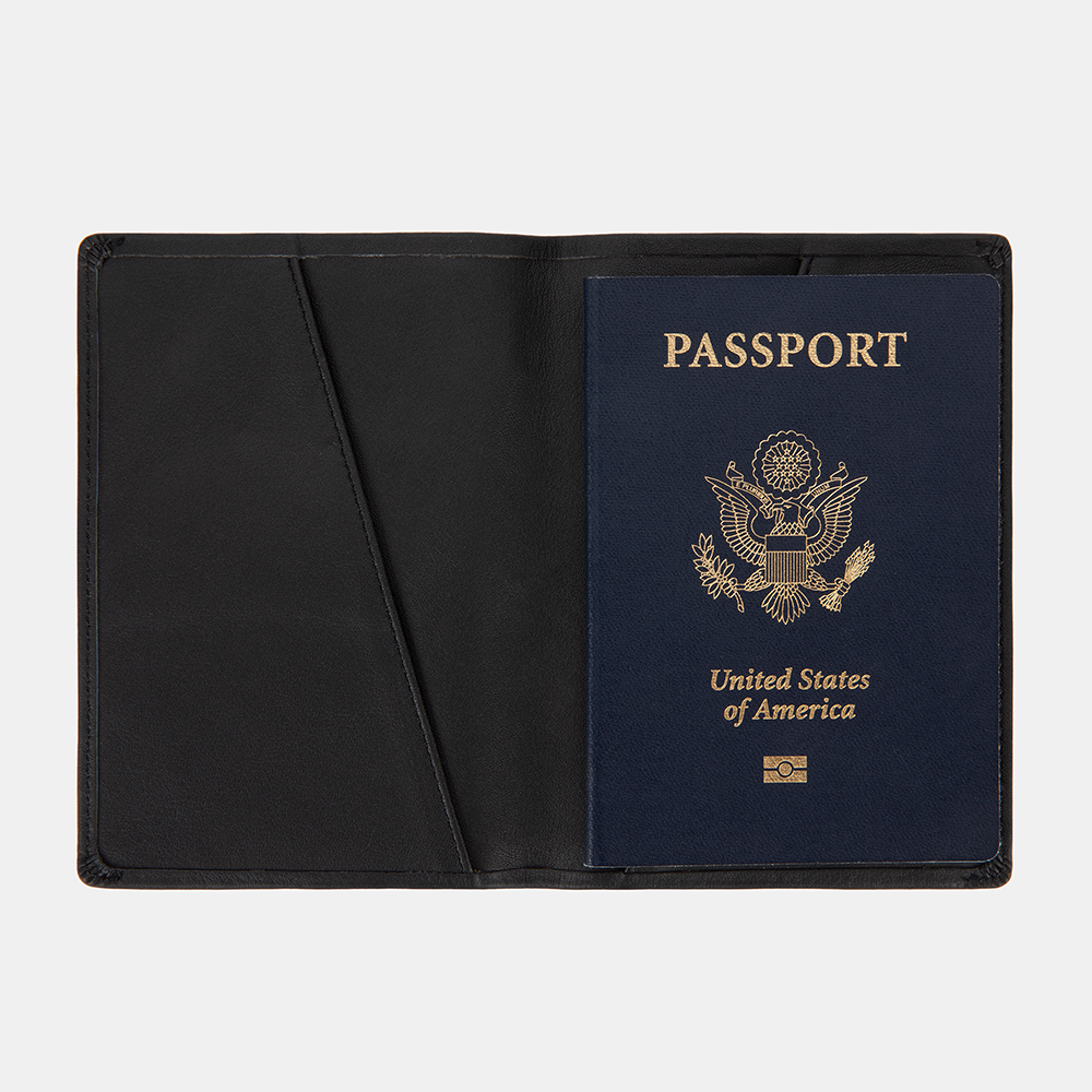 SLNT RFID Passport Wallet open displaying a blue US passport with gold emblem inside black leather interior.