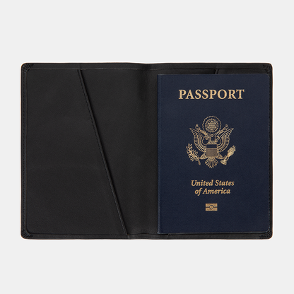 SLNT RFID Passport Wallet open displaying a blue US passport with gold emblem inside black leather interior.
