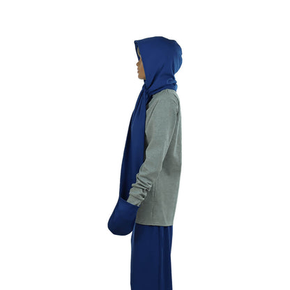 Woman wearing hooded scarf with pockets in navy blue and gray, side view showing draping and fit.