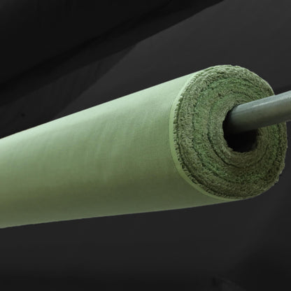 Rolled LessEMF Staticot Shielding Fabric in sage green, showing the woven textile texture and rod through the center.
