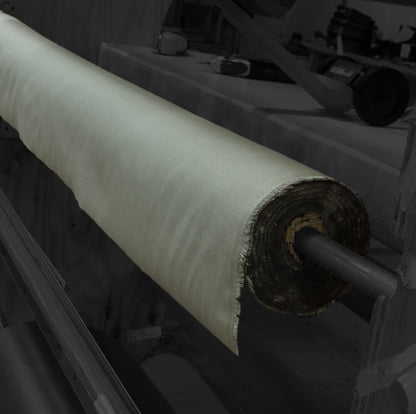 TechniCot Shielding Fabric rolled on a tube, showing white woven material with dark backing.