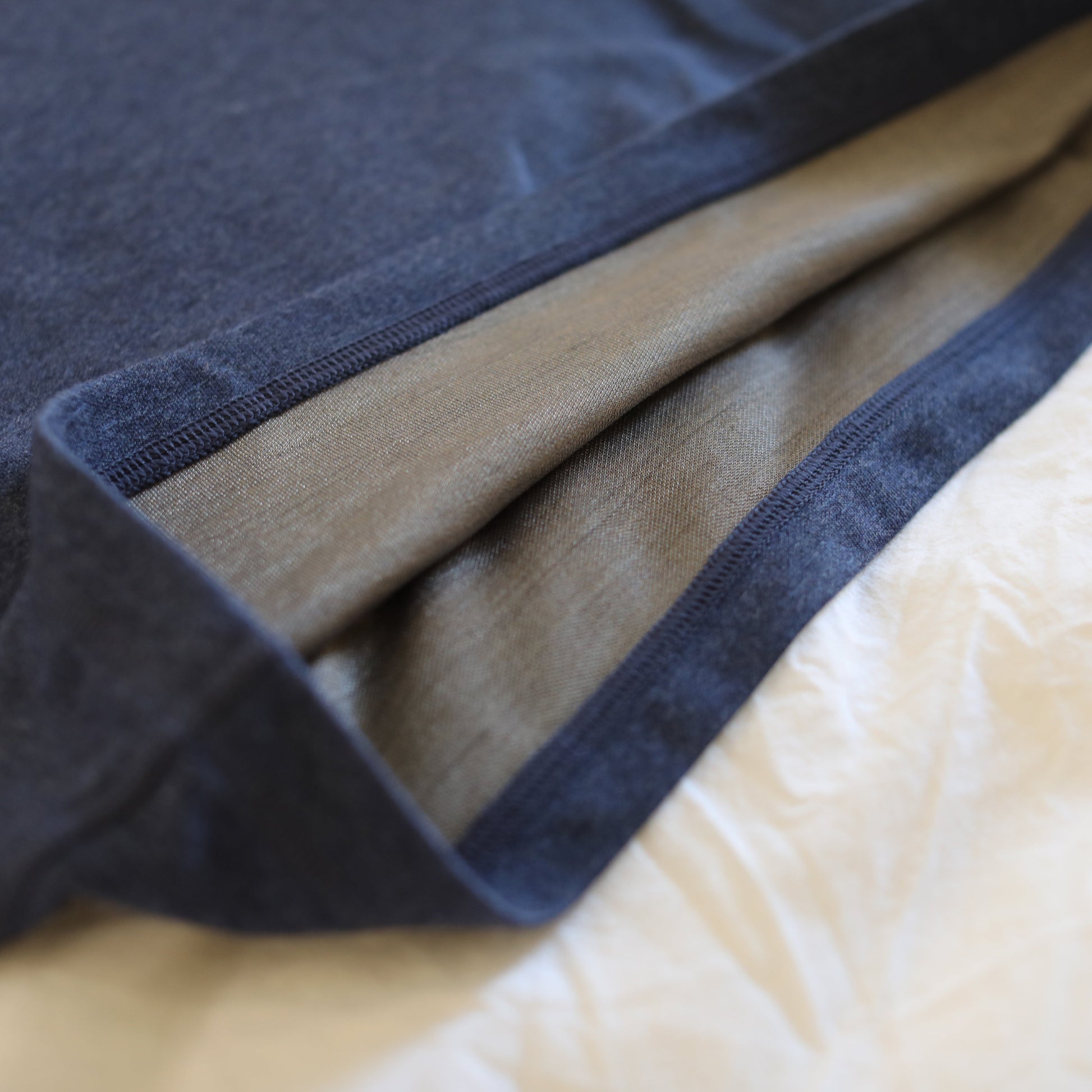 Stacked HAVN WaveStopper™ Pajama Set in navy, tan, and cream colors showing fabric texture and hems.