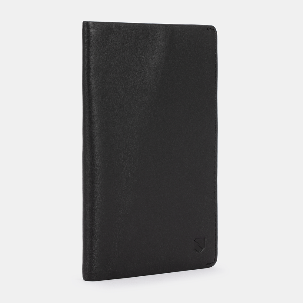 Black SLNT RFID Passport Wallet displayed at an angle against a light background, showing the front cover and spine with embossed logo.