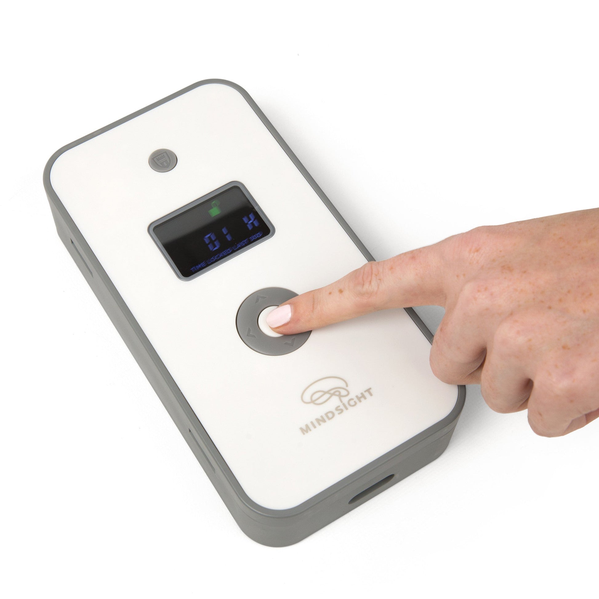 Person's finger pressing button on white Mindsight Timed Lock Box displaying blue digital time readout.