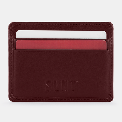 SLNT RFID Wallet in burgundy leather displaying card slots with white and red cards inserted, front view.