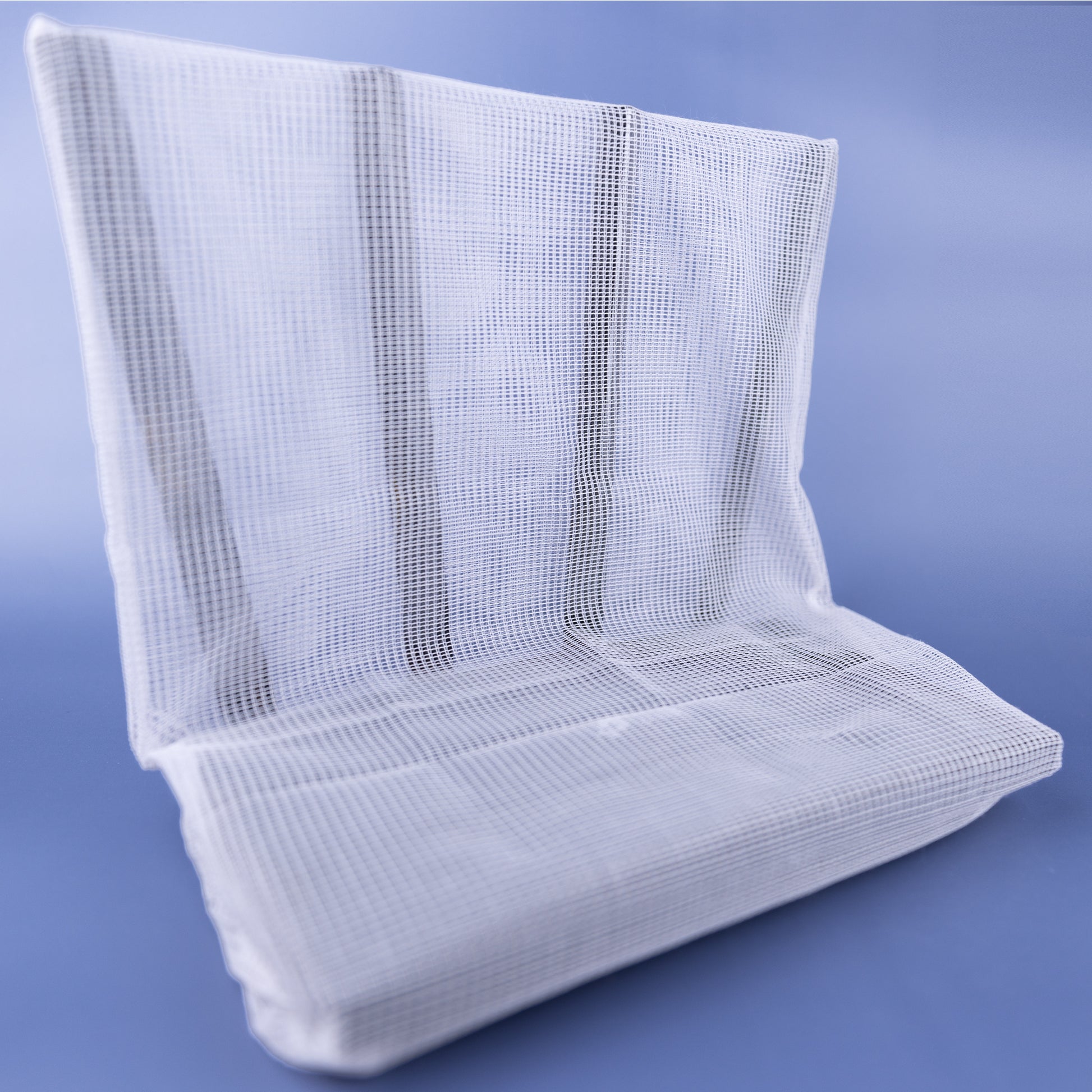 WiFi Signal Tamer mesh shield displayed at angle against blue background, showing woven fabric construction and rectangular form.