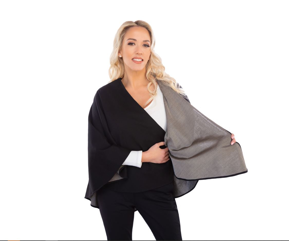 Woman wearing black TRU47 Cotton Double Knit Cape over white top and black pants, cape open to show gray interior lining.