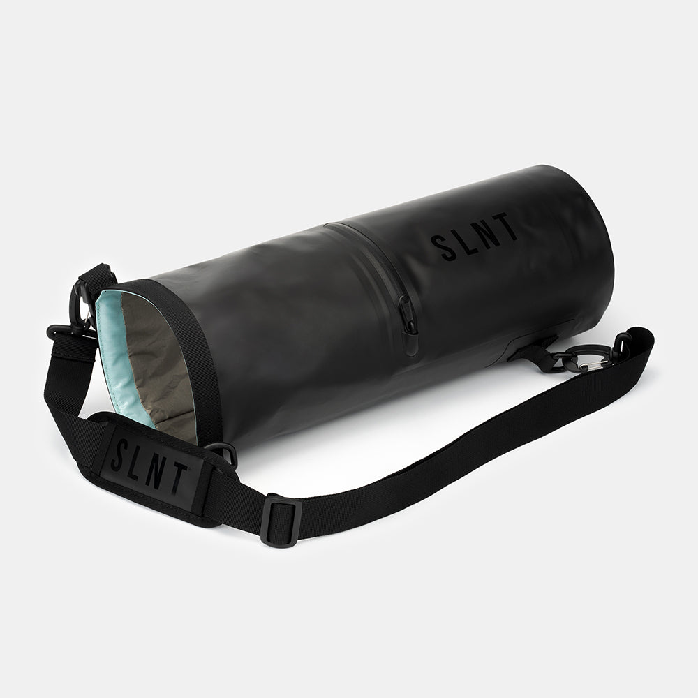 SLNT Faraday Dry Bag with black nylon strap and light blue interior lining displayed at an angle on white background.