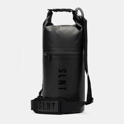 Black SLNT Faraday Dry Bag with rolled top closure, front zipper pocket, shoulder strap, and branded label, shown front view against white background.