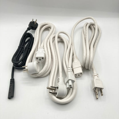 Close view of a white power cord with an angled three-prong grounded plug beside a C13 connector.