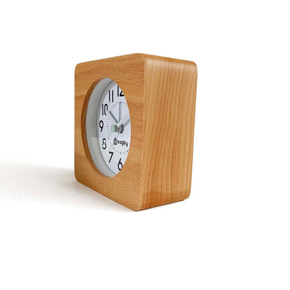 Side view of the beech wood Bagby FARMHOUSE alarm clock showing its square wooden body and white analog dial.